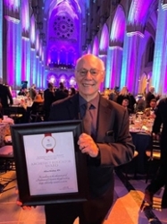 Milton Shinberg posing with his AIA Architect Educator Award