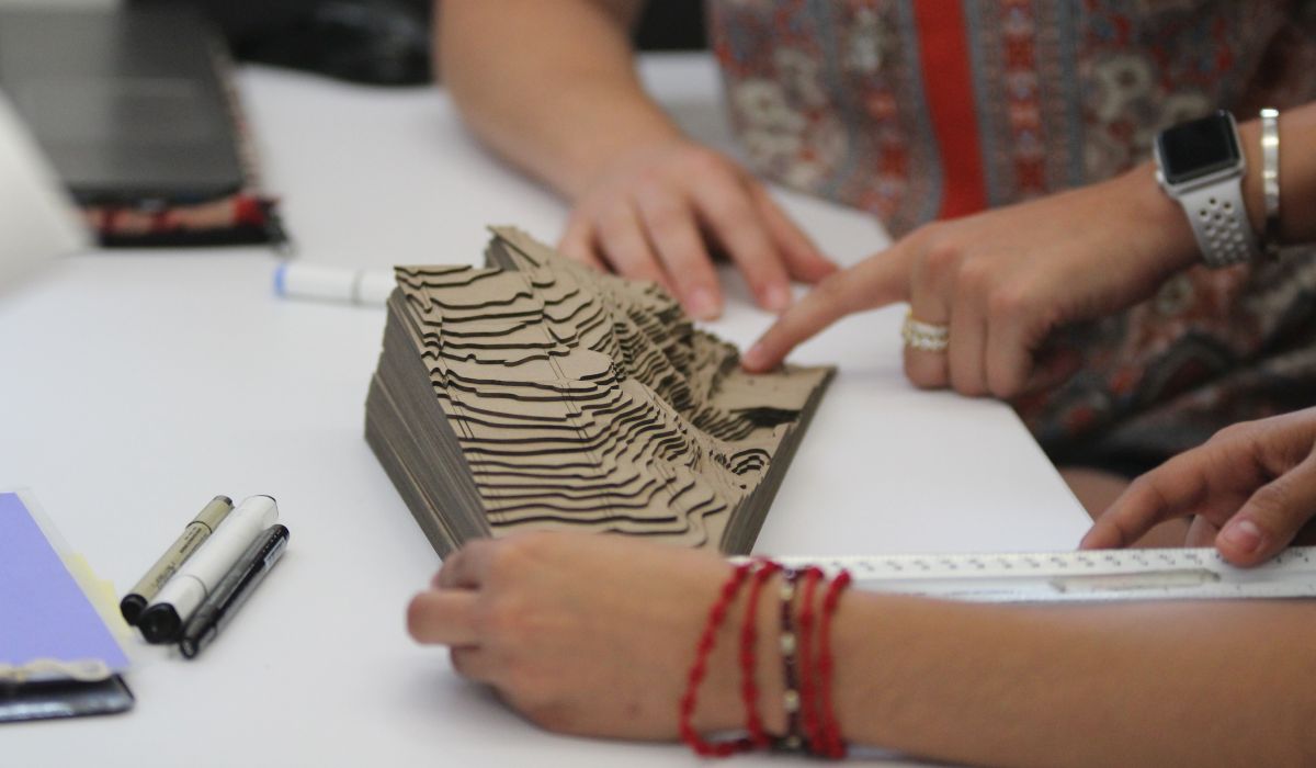 two students reviewing a model